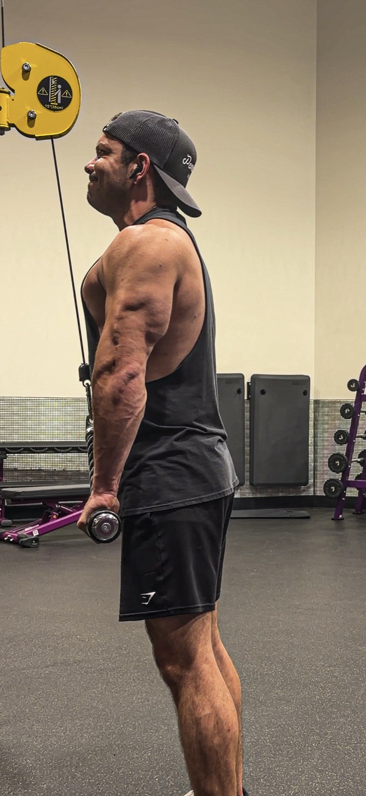 Tyler mid-set on a tricep pushdown